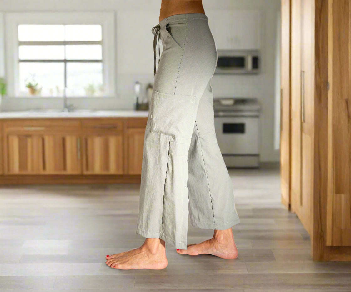 Light gray wide-leg pants with a drawstring waist on a white background
