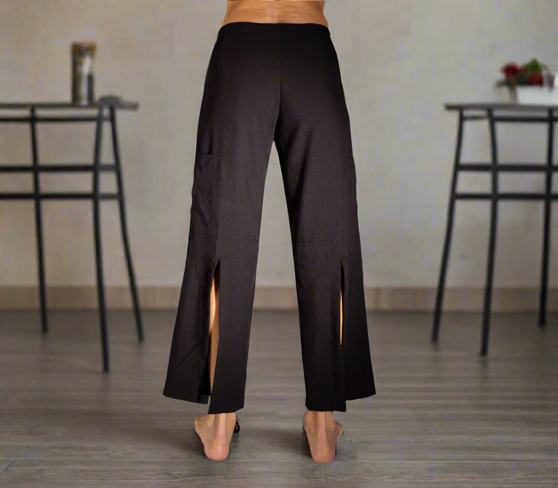 Black wide-leg pants with side slits on a plain background